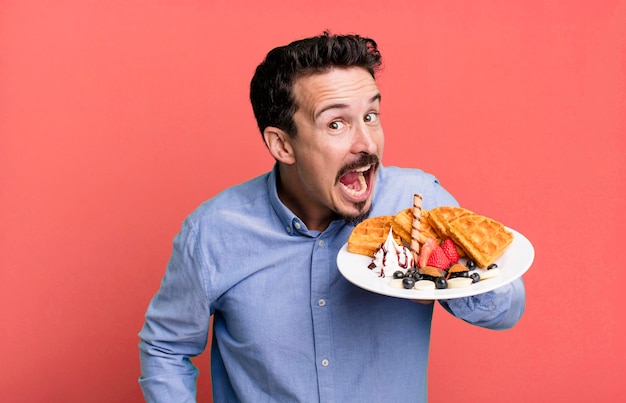 Adult man having waffles for breakfast