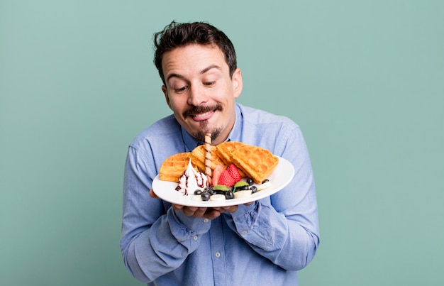 Adult man having waffles for breakfast