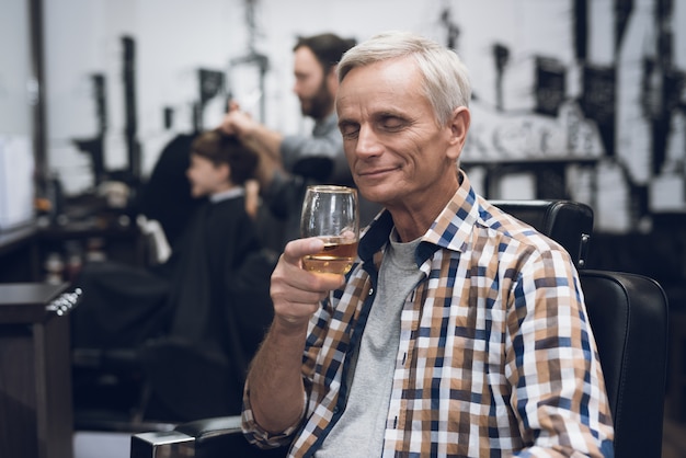 The adult man is sheared in barbershop.