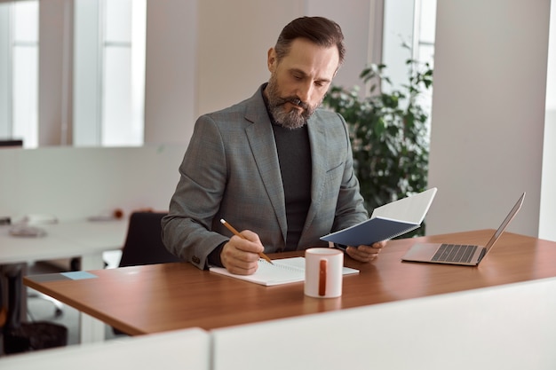 Adult man is working in a modern office