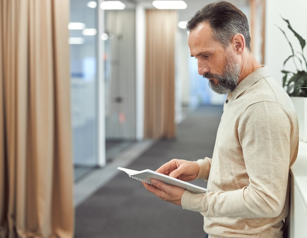 Adult man is working in a modern office