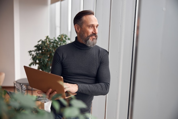 Adult man is working in a modern office