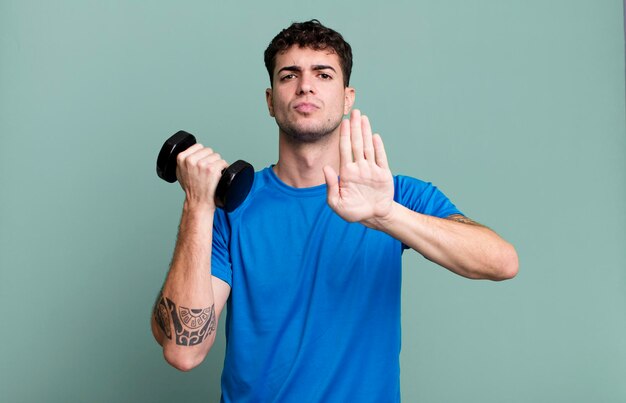 Adult man lifting a dumbbell and fitness concept