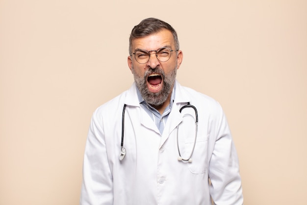 Adult man shouting aggressively, looking very angry