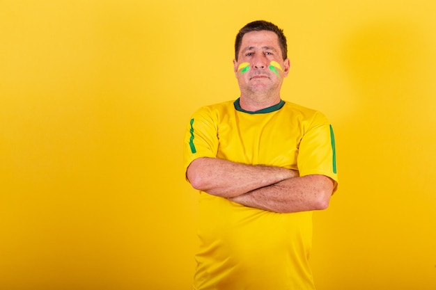 Adult man soccer fan from brazil with his arms crossed