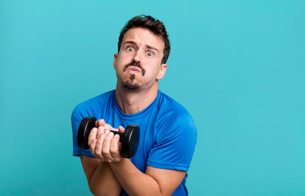 Adult man training and lifting a dumbbell