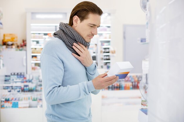 Adult man with a scarf in a drugstore