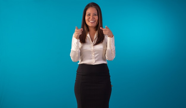 Adult oriental woman wearing formal wear in studio photo with blue background.