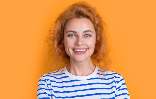 Adult redhead woman face isolated on yellow background face of young redhead woman