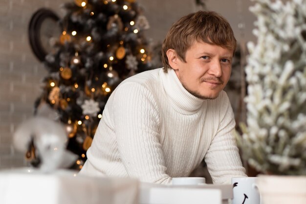 Adult smiling looking at camera man at Christmas decorated home