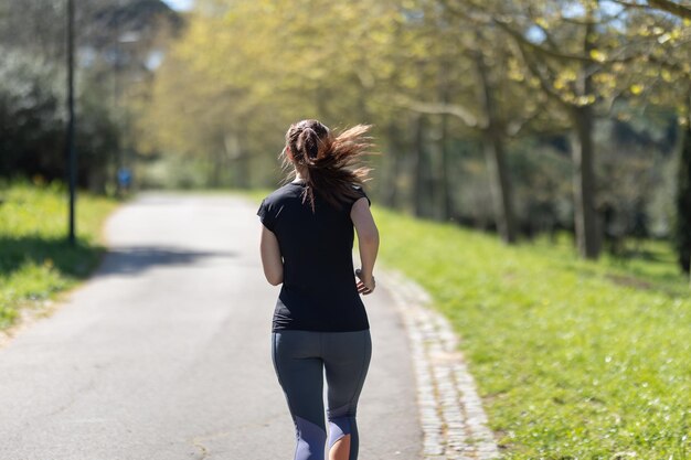 Adult sportive woman jogging in the park