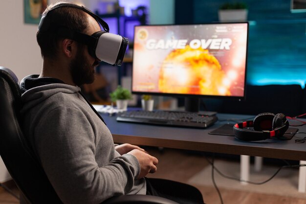 Free Photo  Person playing video games with controller on computer. player  using joystick and wearing headphones to play online game on monitor.  modern man using gaming equipment to have fun.