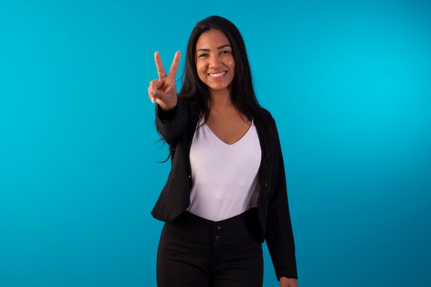 Adult woman in business suit style suit with facial expressions and holding a sign.