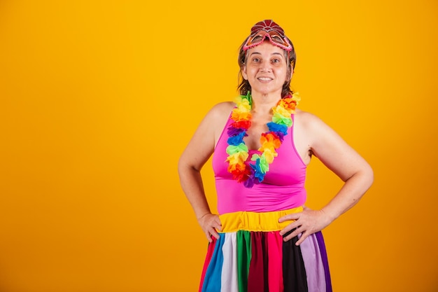 Adult woman in carnival clothes smiling at camera with hands on hips