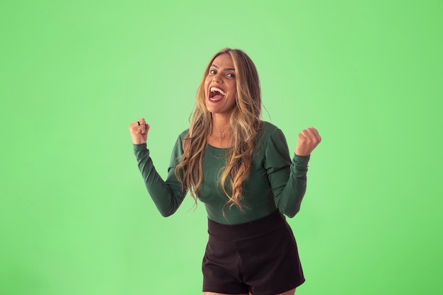 Adult woman doing poses and facial expressions in studio photo.