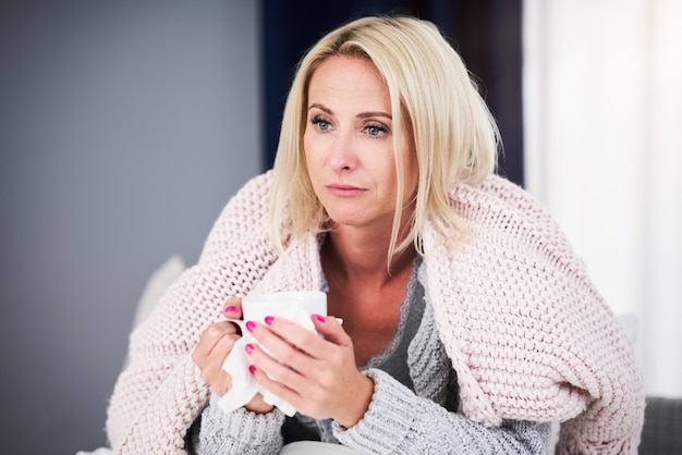 Adult woman feeling unewll and suffering from flu at home