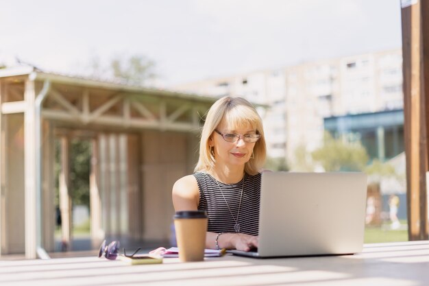 Adult Woman in glasses with laptop