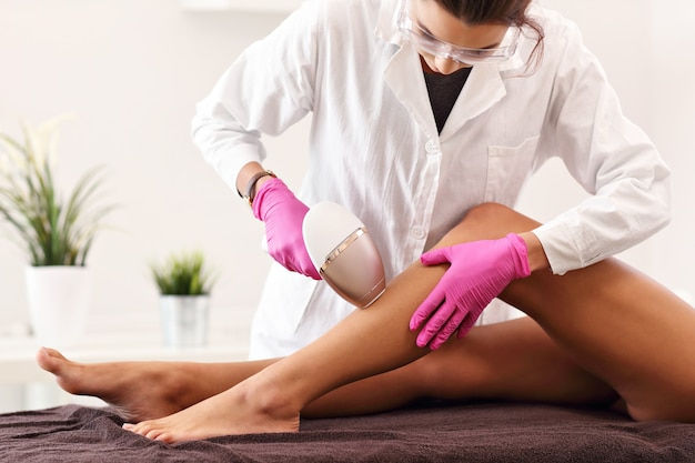 adult woman having laser hair removal in professional beauty salon