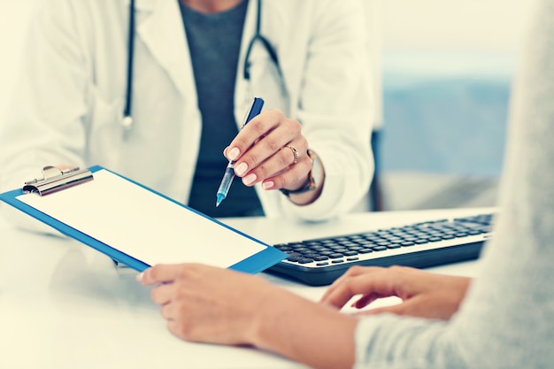 adult woman having a visit at female doctor's office