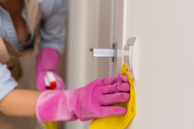 Adult woman is cleaning the apartment