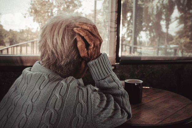 adult woman old person has a headache concept loneliness dementia abuse sadness healthcare