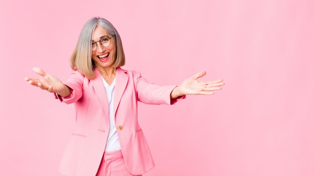 adult woman in pink suit giving a warm friendly hug