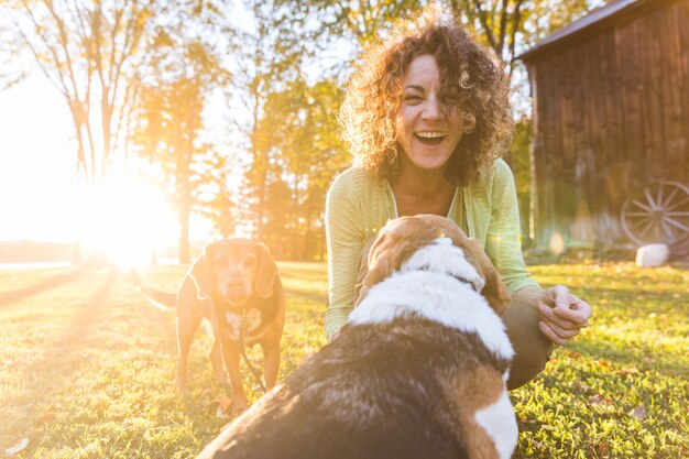 Adult woman playing with her dogs at park