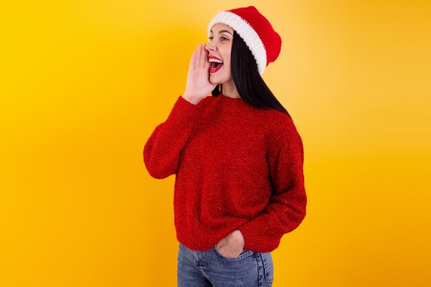 Adult woman posing with a Santa Claus hat