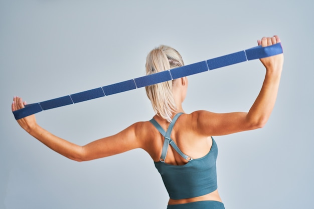 adult woman practicing with stretching belt