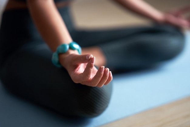 adult woman practicing yoga at home