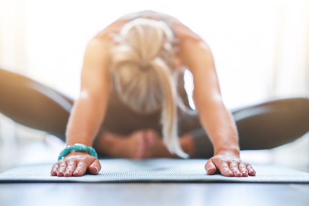 adult woman practising yoga at home