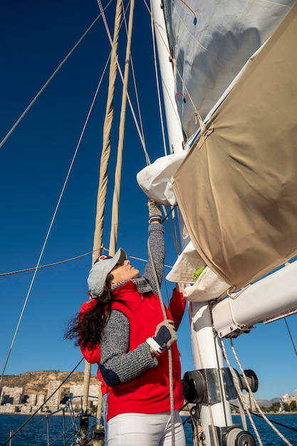 Adult Woman Pulling Rope on Sailboat Alicante Costa Blanca Spain