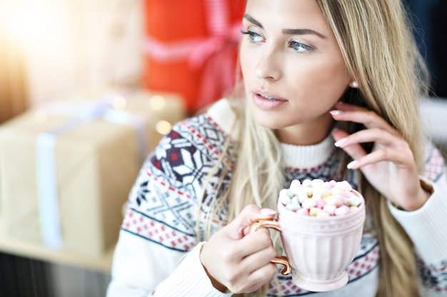 adult woman relaxing at home during Christmas time