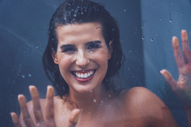 Adult woman under the shower in bathroom