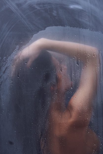 Adult woman under the shower in bathroom