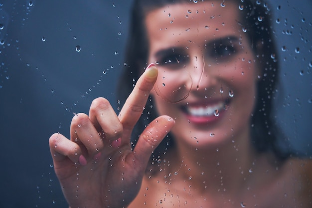 Adult woman under the shower in bathroom