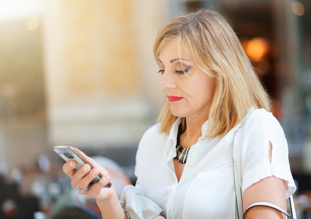 Adult woman uses the smartphone