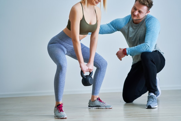 Adult woman with her personal fitness trainer