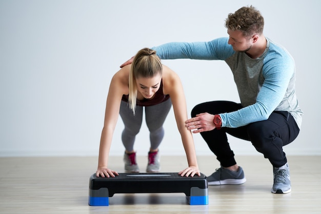 Adult woman with her personal fitness trainer