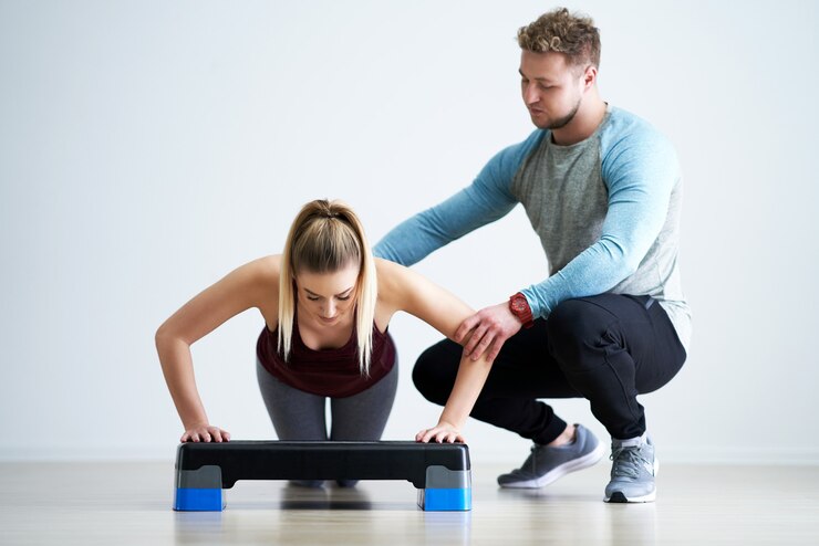 Adult woman with her personal fitness trainer