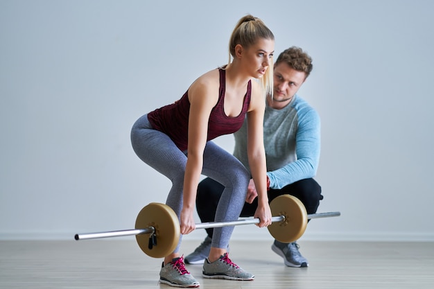 Adult woman with her personal fitness trainer