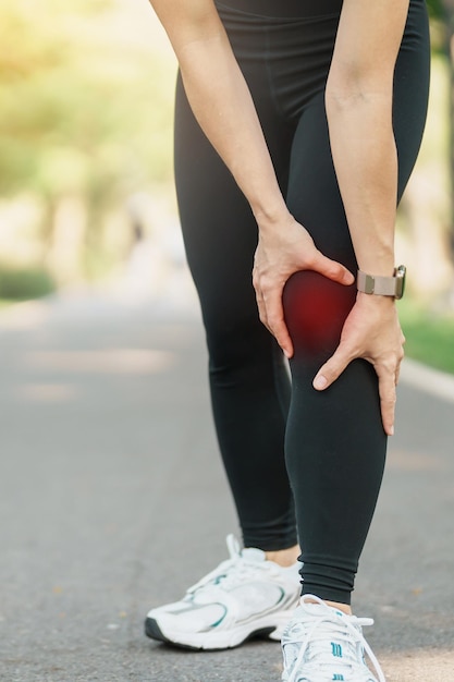 La donna adulta con dolore muscolare durante la corsa del corridore ha dolore al ginocchio a causa dell'artrosi del ginocchio del corridore o della sindrome del dolore femoro-rotuleo e della tendinite rotulea lesioni sportive e concetto medico