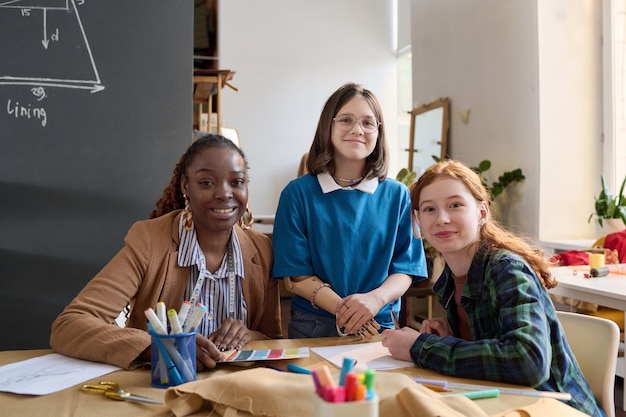 Adult woman with two teenage girls in atelier