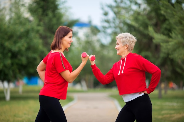 Adult women in sportswear exercising in the park