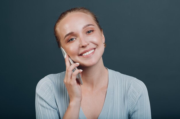 Adult young woman smile portrait in studio mobile phone