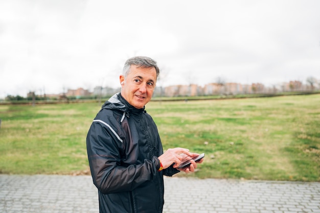 Adults athlete with his phone after running.