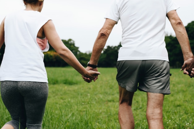 Adults holding hands in the park