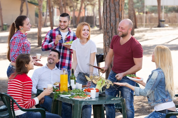 Adults relaxing at grill party