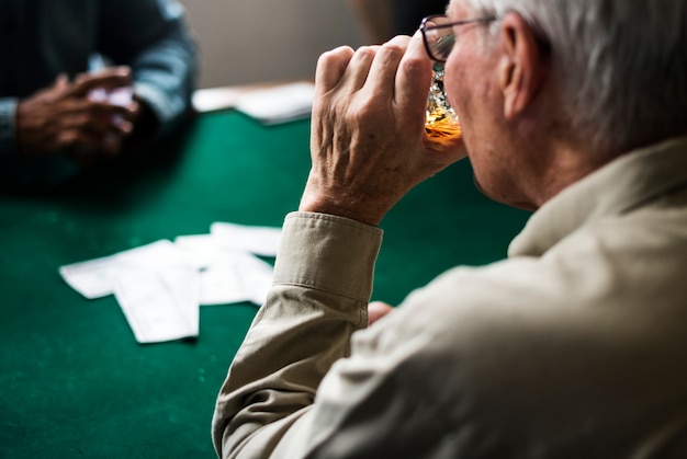 Adults socialising and playing cards 