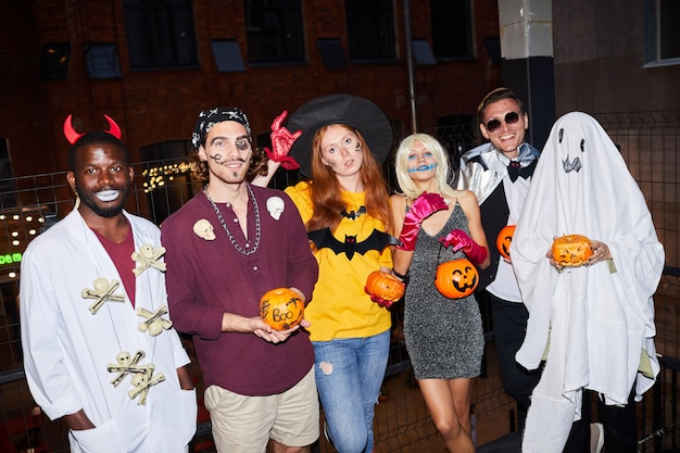 Photo adults wearing halloween costumes in nightclub